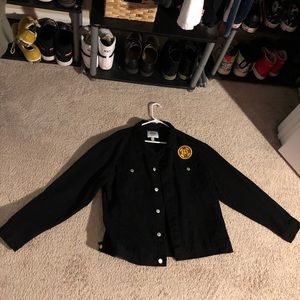Black denim jacket with a sewed on smiley face on the front and back size Large